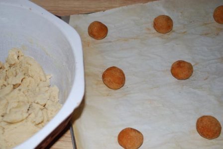 dough balls covered in cinnamon and sugar placed on a parchment lined cookie sheet with&hellip;
